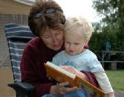 woman_reading_to_boy_outside.jpg